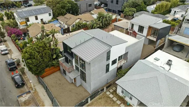 an aerial view of a house with a yard
