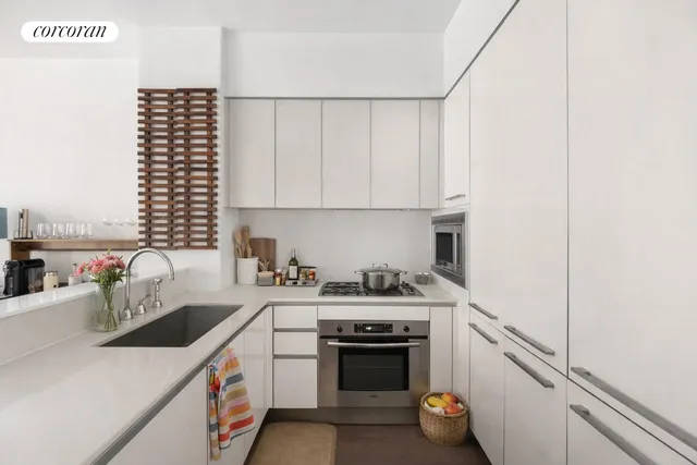 a living room with furniture potted plant and a large window