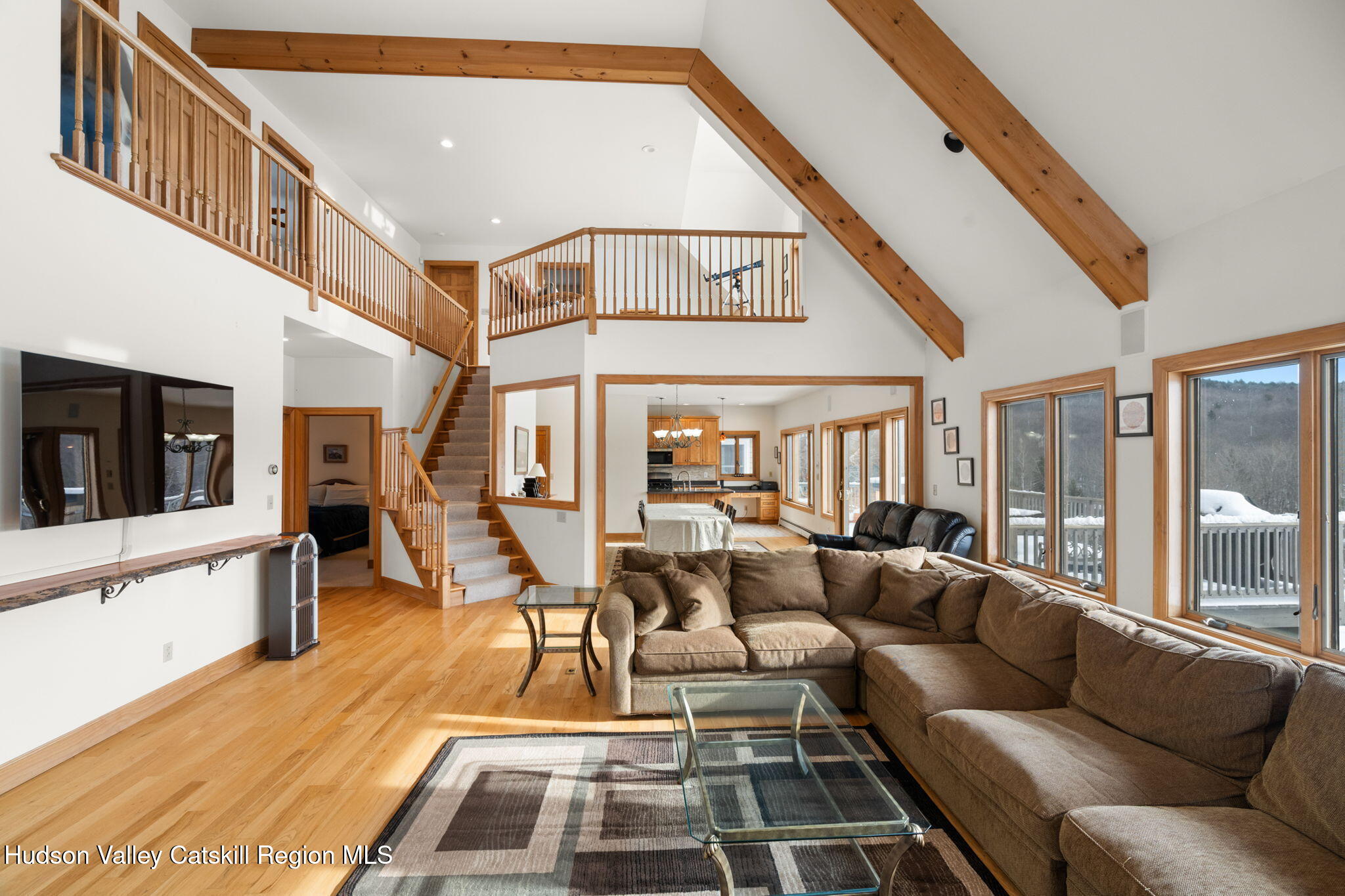 2 Biff Andrus Road Windham, NY 12496 - Photo 15 of 35 a living room with furniture a flat screen tv and a floor to ceiling window