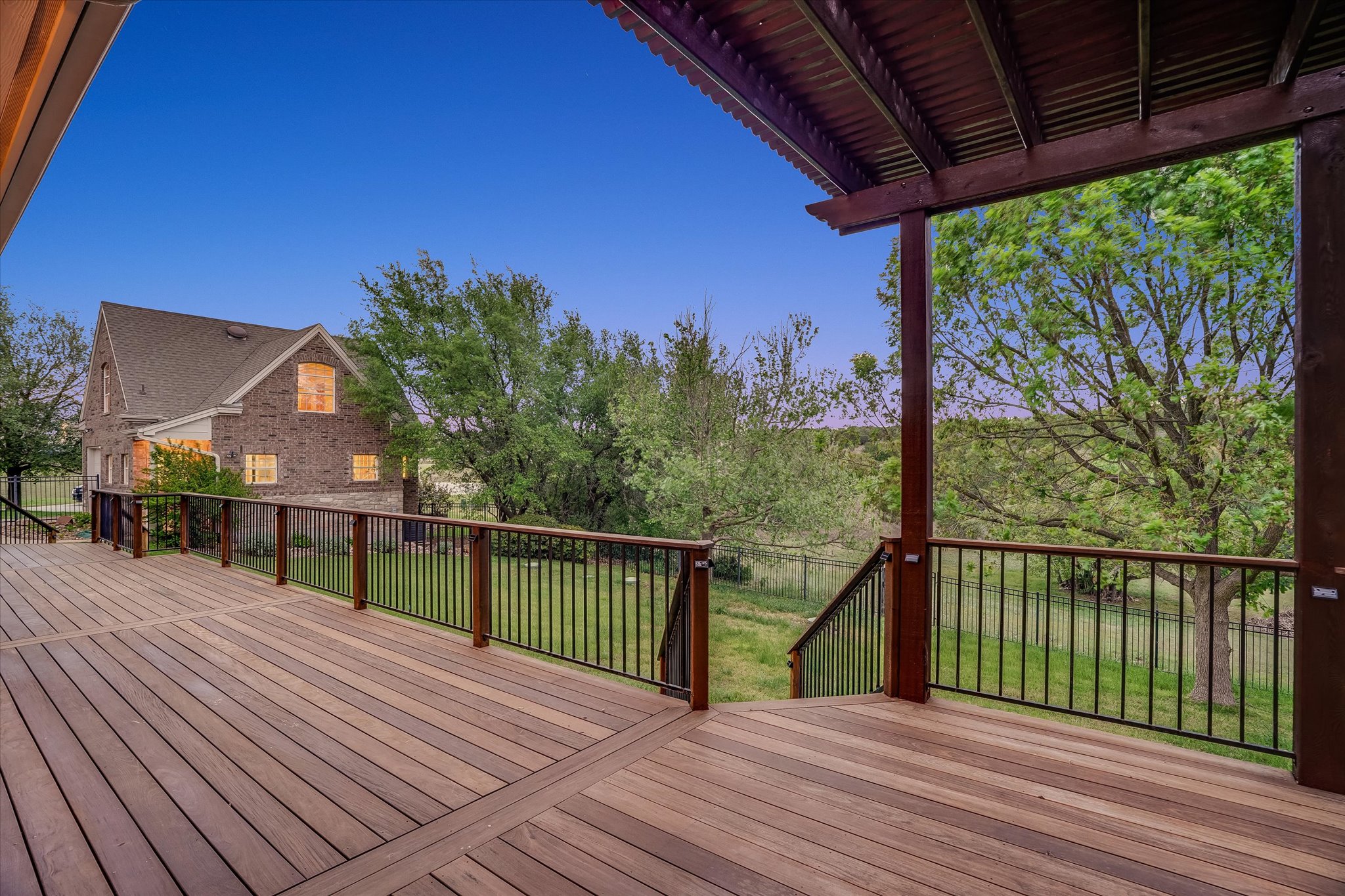 1400 Tom Sawyer Road Austin, TX 78737 - Photo 30 of 40 Expansive deck with multiple seating areas and seamless indoor-outdoor flow.
