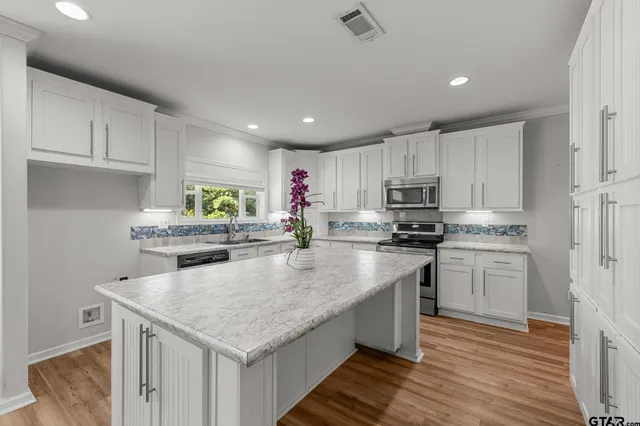 a kitchen with granite countertop stainless steel appliances and wooden cabinets