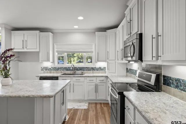 a kitchen with a sink stove and cabinets
