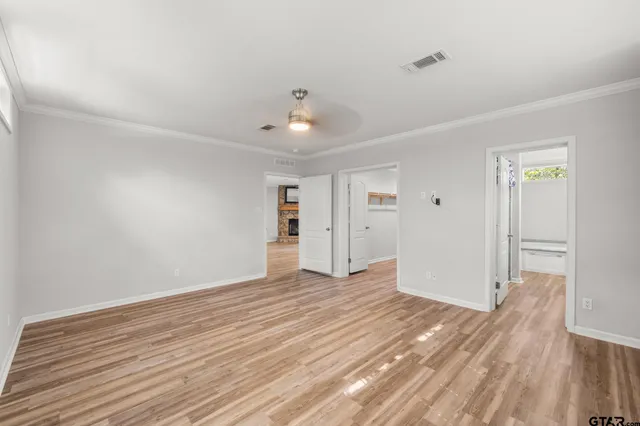 a view of an empty room with wooden floor