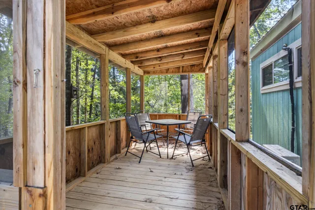 a balcony with chairs and wooden floor