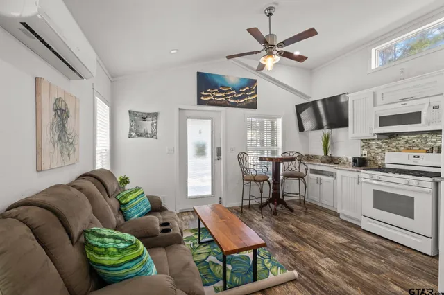 a living room with furniture and kitchen view