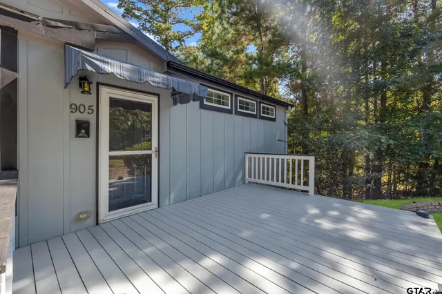 a view of backyard with deck and wooden floor