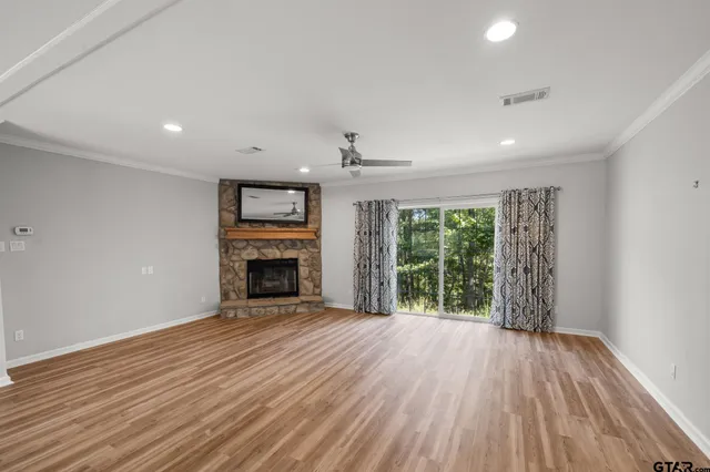 wooden floor fireplace and natural light in room
