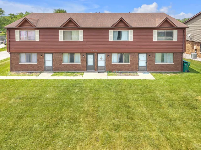 a front view of a house having yard and deck