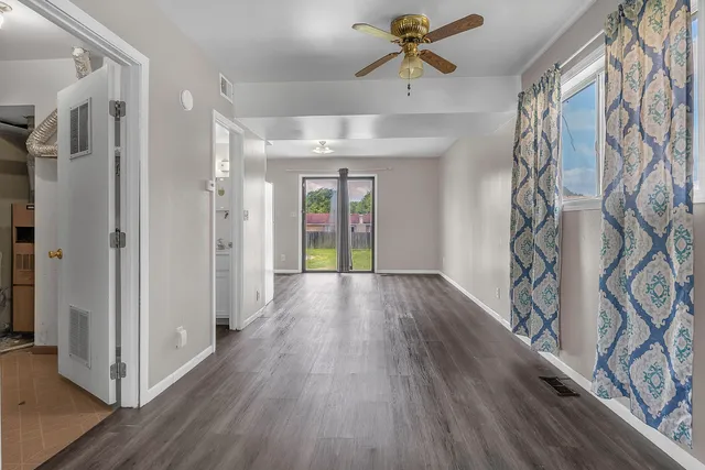 a view of a hallway view with wooden floor and staircase