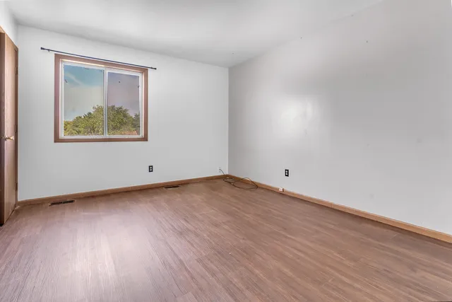 a view of an empty room and wooden floor