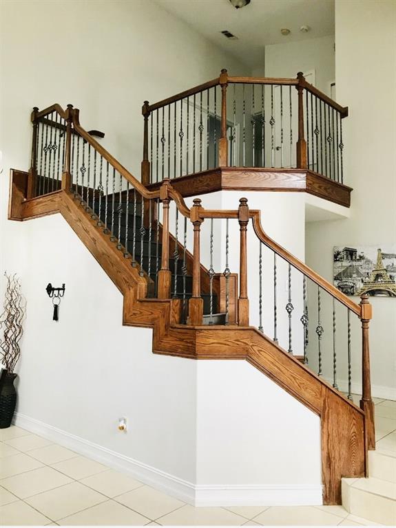 5219 Mystic Point Court Orlando, FL 32812 - Photo 2 of 13 a view of staircase with lots of frames on wall and wooden floor