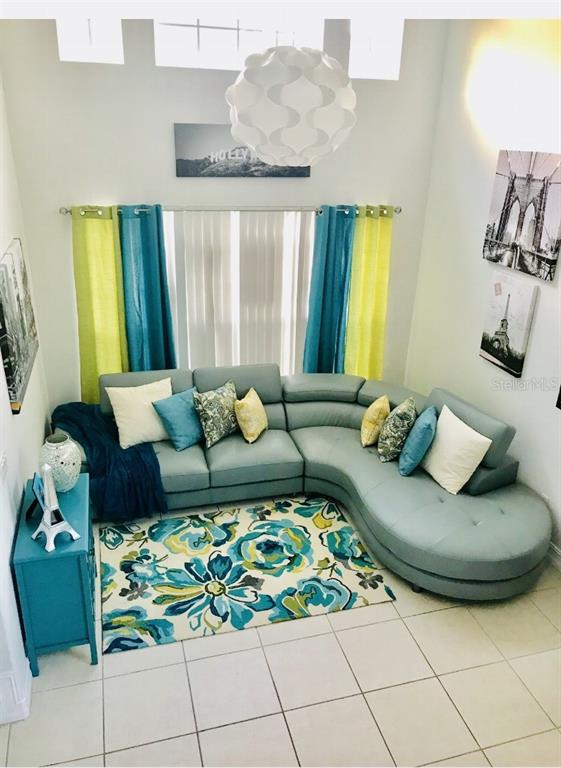 5219 Mystic Point Court Orlando, FL 32812 - Photo 3 of 13 a living room with furniture and a potted plant