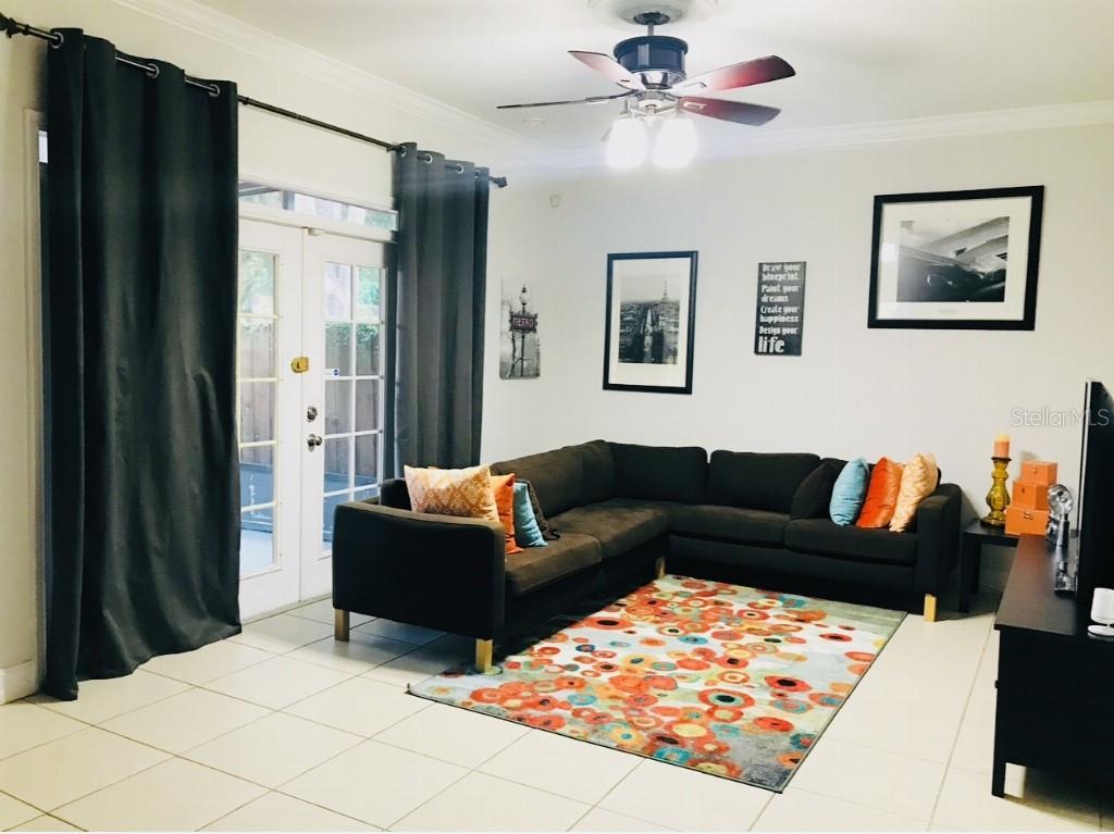 5219 Mystic Point Court Orlando, FL 32812 - Photo 4 of 13 a living room with furniture and a bed