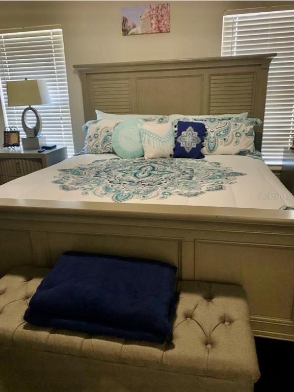 5219 Mystic Point Court Orlando, FL 32812 - Photo 8 of 13 a bedroom with a bed and window