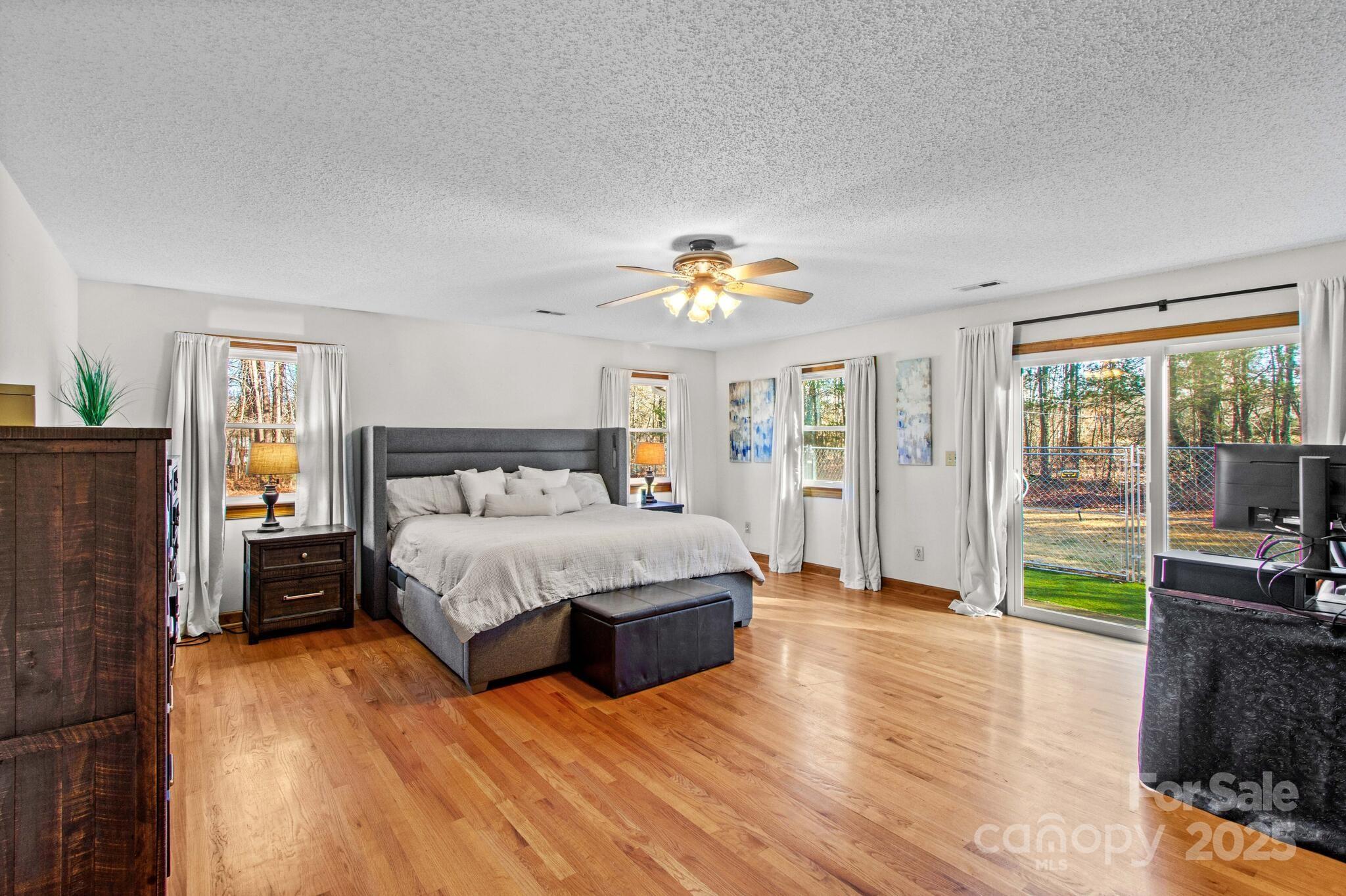 295 Rimer Road Salisbury, NC 28146 - Photo 17 of 48 a spacious bedroom with a bed and wooden floor