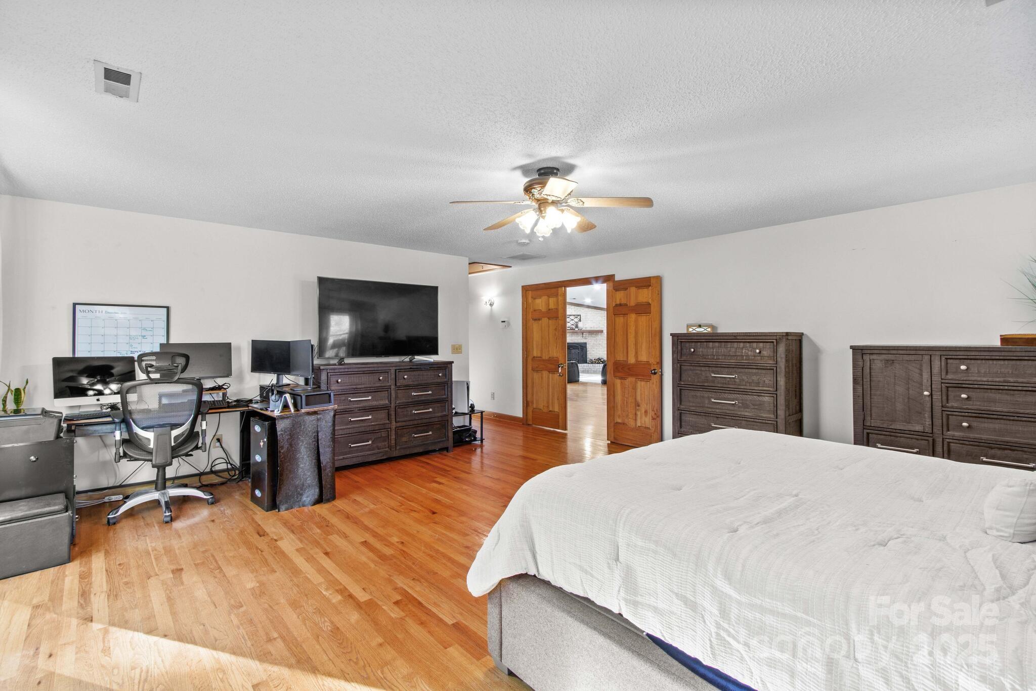 295 Rimer Road Salisbury, NC 28146 - Photo 18 of 48 a bedroom with a bed and a flat screen tv