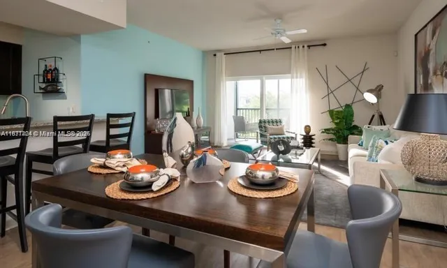 a room with furniture a dining table and a large window