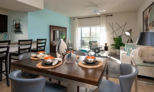 a dining room with kitchen island granite countertop furniture a chandelier and kitchen view