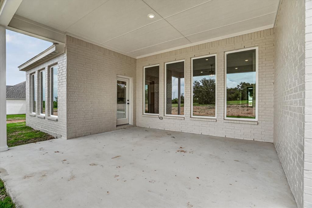 317 Skeen Peak Springtown, TX 76082 - Photo 30 of 31 Covered patio with a concrete slab, recessed ceiling lighting, and light-colored brick exterior