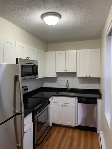 a kitchen with a sink stove and microwave