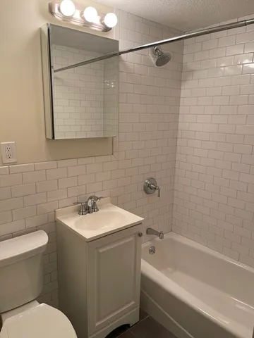 a bathroom with a sink mirror toilet and bathtub