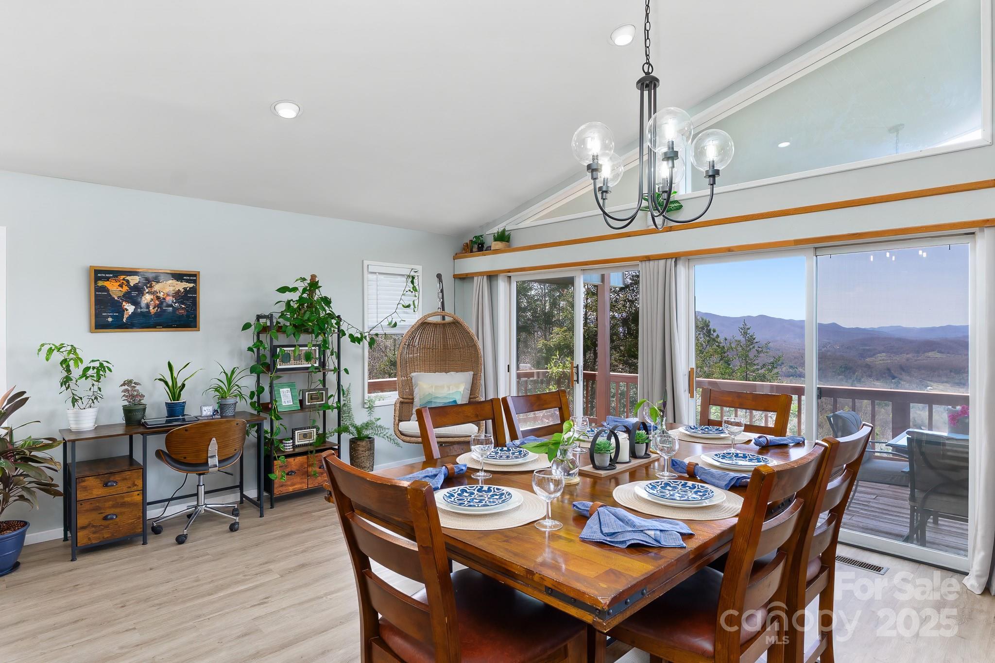 727 Chinquapin Mountain Road Franklin, NC 28734 - Photo 16 of 47 a dining room with furniture a large window and a chandelier