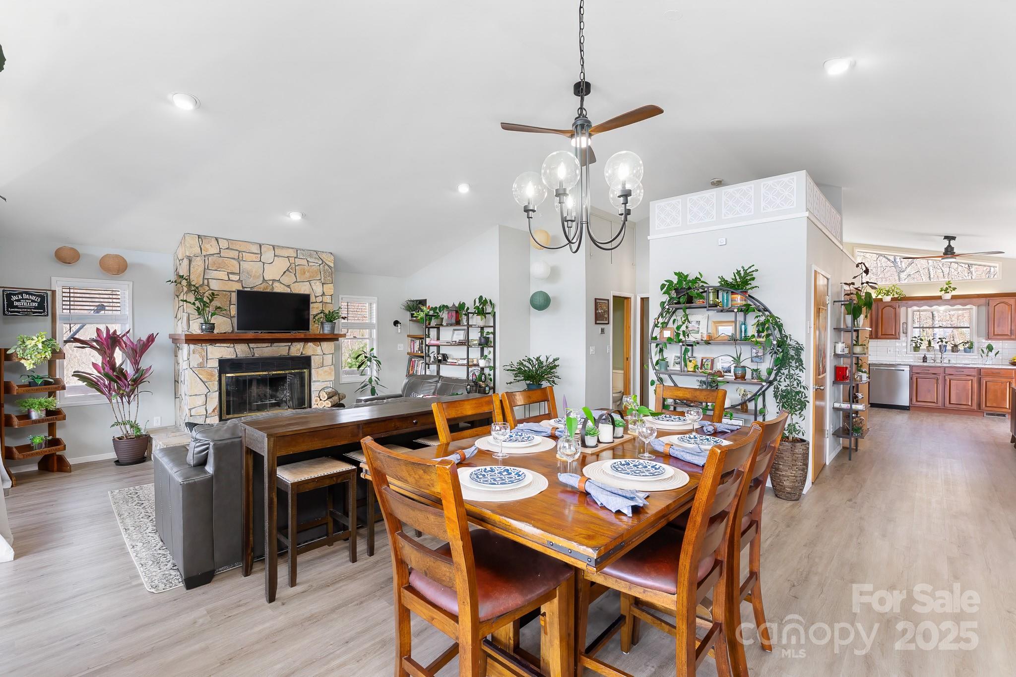 727 Chinquapin Mountain Road Franklin, NC 28734 - Photo 17 of 47 a view of a dining room with furniture wooden floor and chandelier