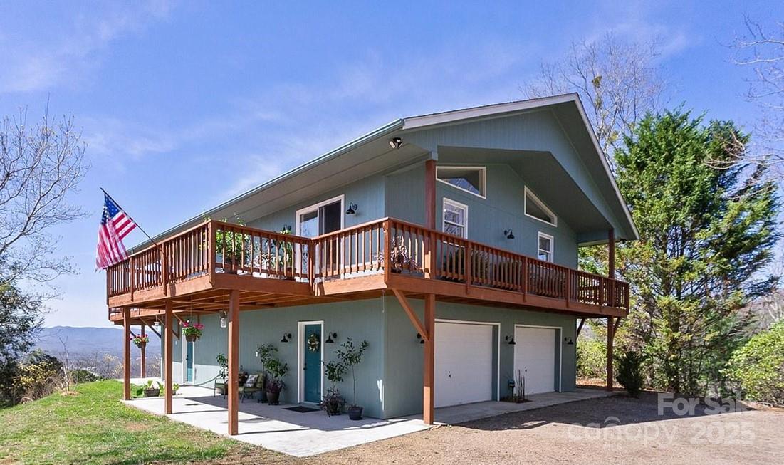 727 Chinquapin Mountain Road Franklin, NC 28734 - Photo 2 of 47 a front view of a house with a garden
