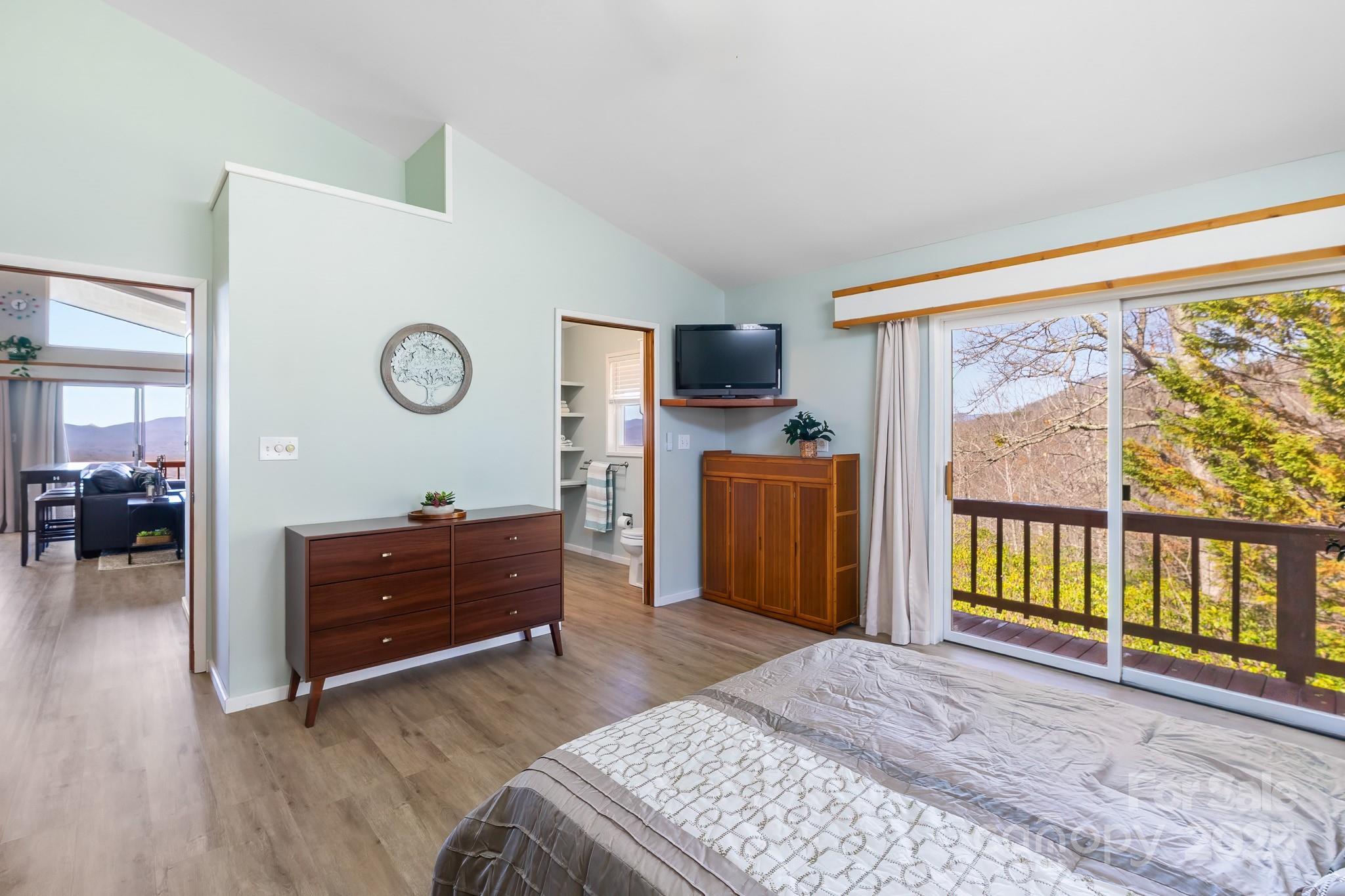 727 Chinquapin Mountain Road Franklin, NC 28734 - Photo 25 of 47 a bed room with a bed and a television