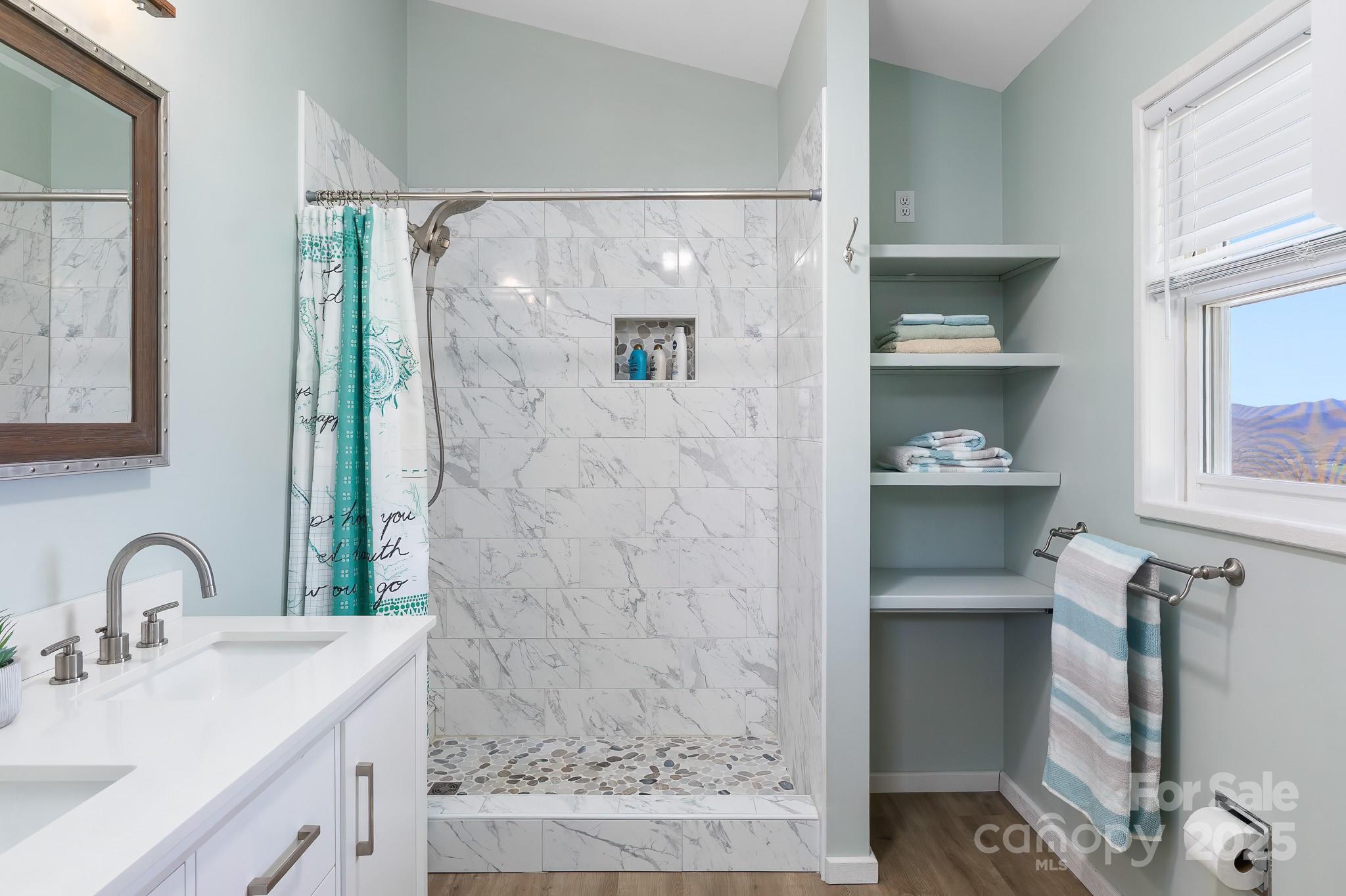 727 Chinquapin Mountain Road Franklin, NC 28734 - Photo 26 of 47 a bathroom with a sink and a mirror