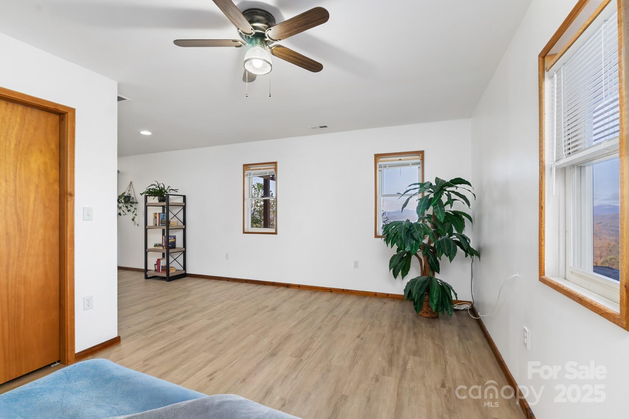 727 Chinquapin Mountain Road Franklin, NC 28734 - Photo 28 of 47 a view of an empty room with wooden floor and a window