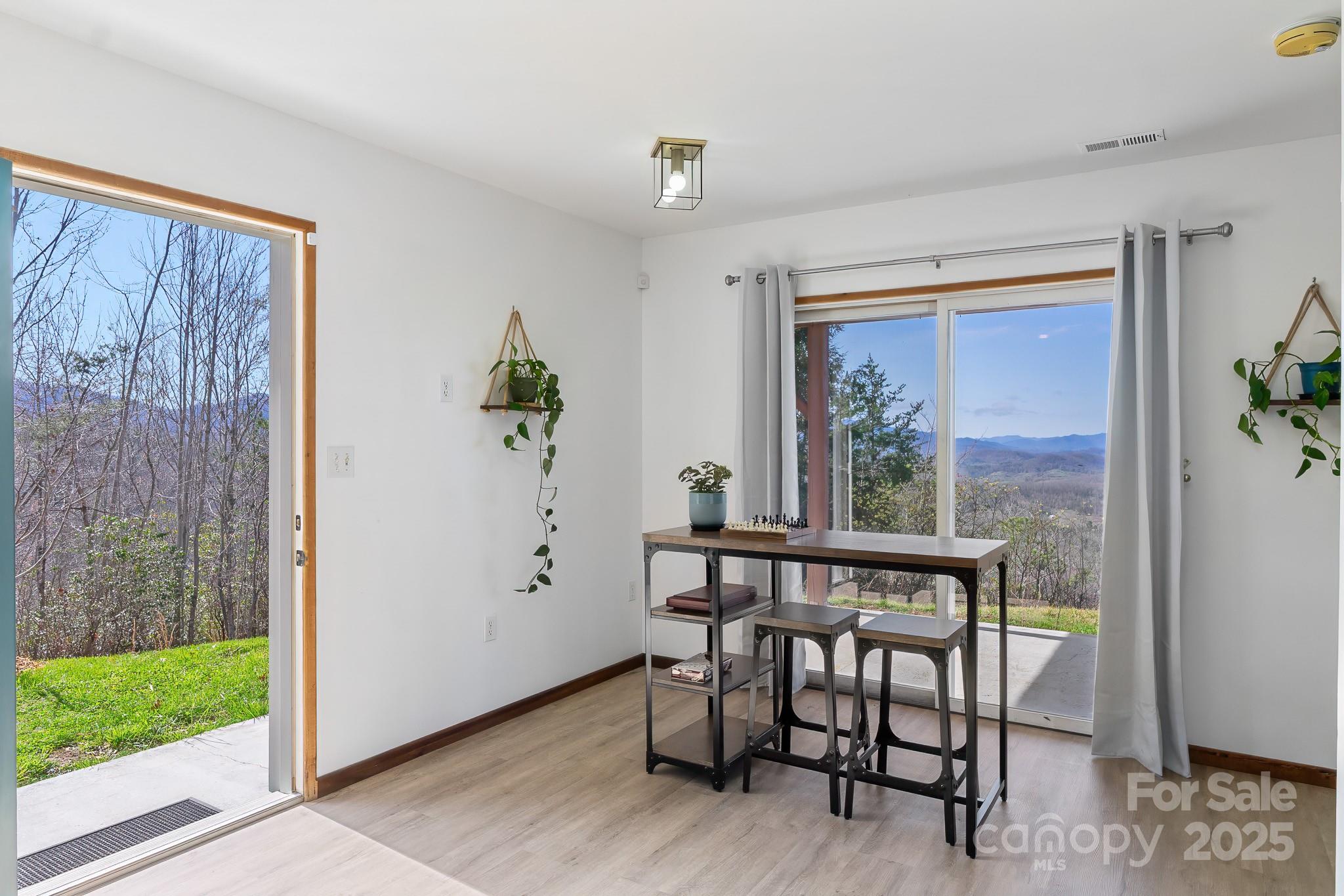 727 Chinquapin Mountain Road Franklin, NC 28734 - Photo 30 of 47 a view of a dining room with furniture window and wooden floor