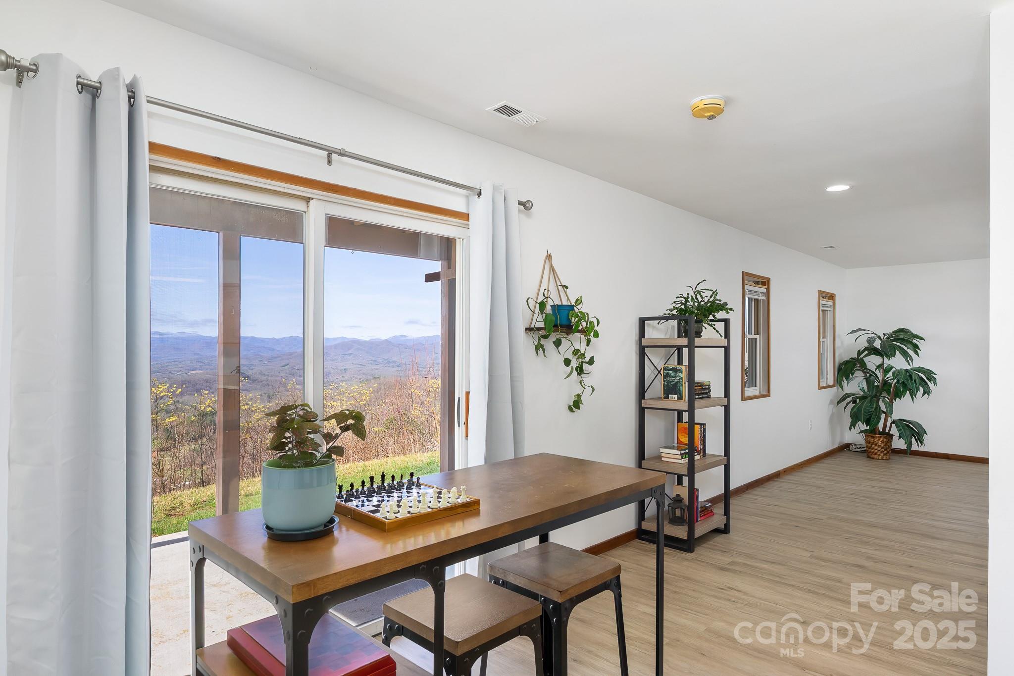 727 Chinquapin Mountain Road Franklin, NC 28734 - Photo 31 of 47 a dining room with furniture and a potted plant