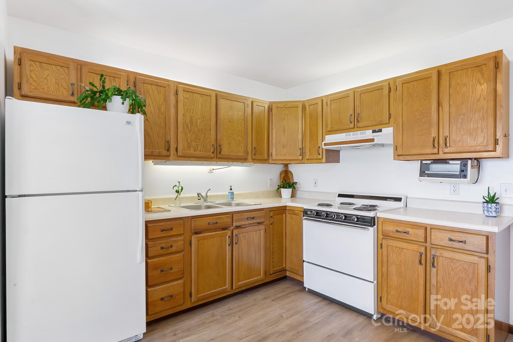 727 Chinquapin Mountain Road Franklin, NC 28734 - Photo 32 of 47 a kitchen with a white cabinets and white appliances