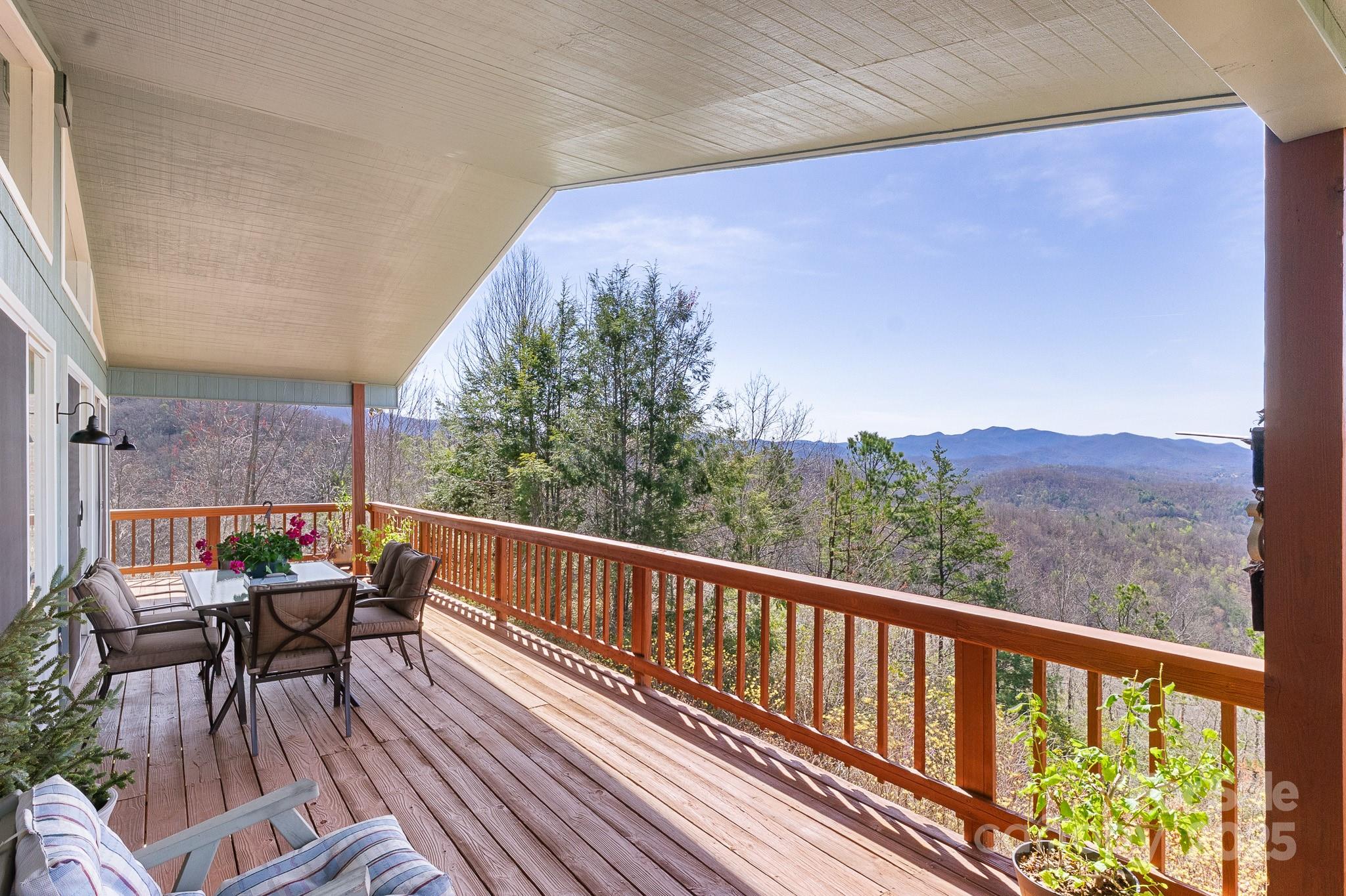 727 Chinquapin Mountain Road Franklin, NC 28734 - Photo 4 of 47 a view of a chairs and table on the wooden floor