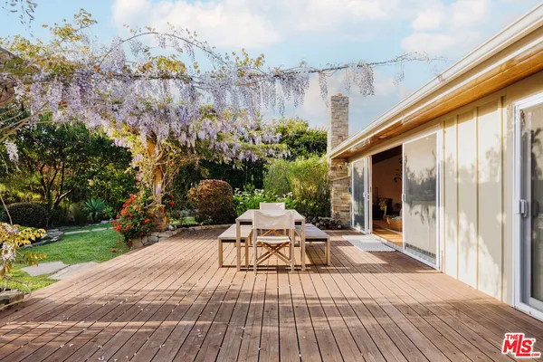 a view of a backyard with sitting area