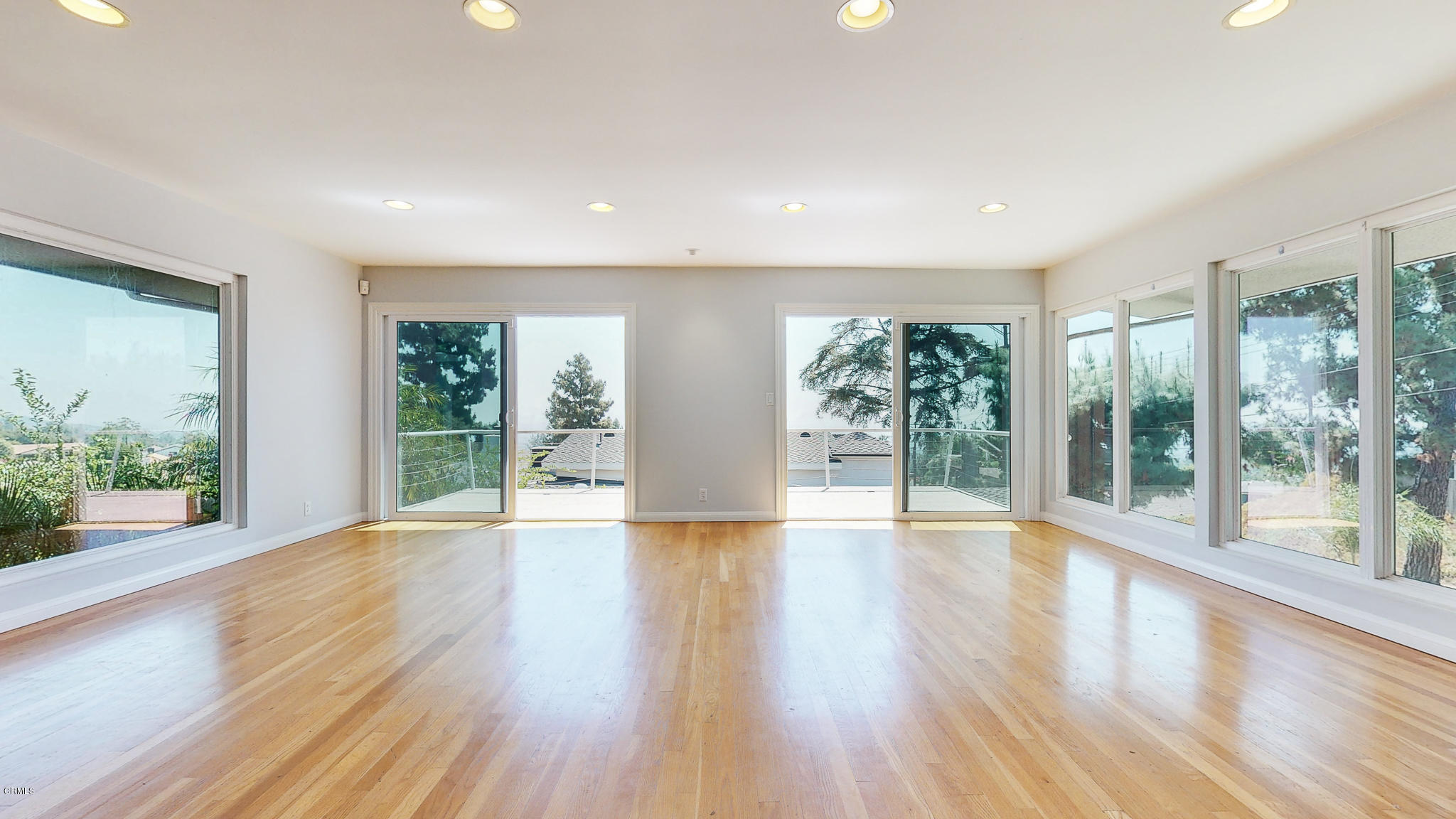 1610 Carriage House Road Pasadena, CA 91107 - Photo 13 of 54 a view of an empty room with wooden floor and windows