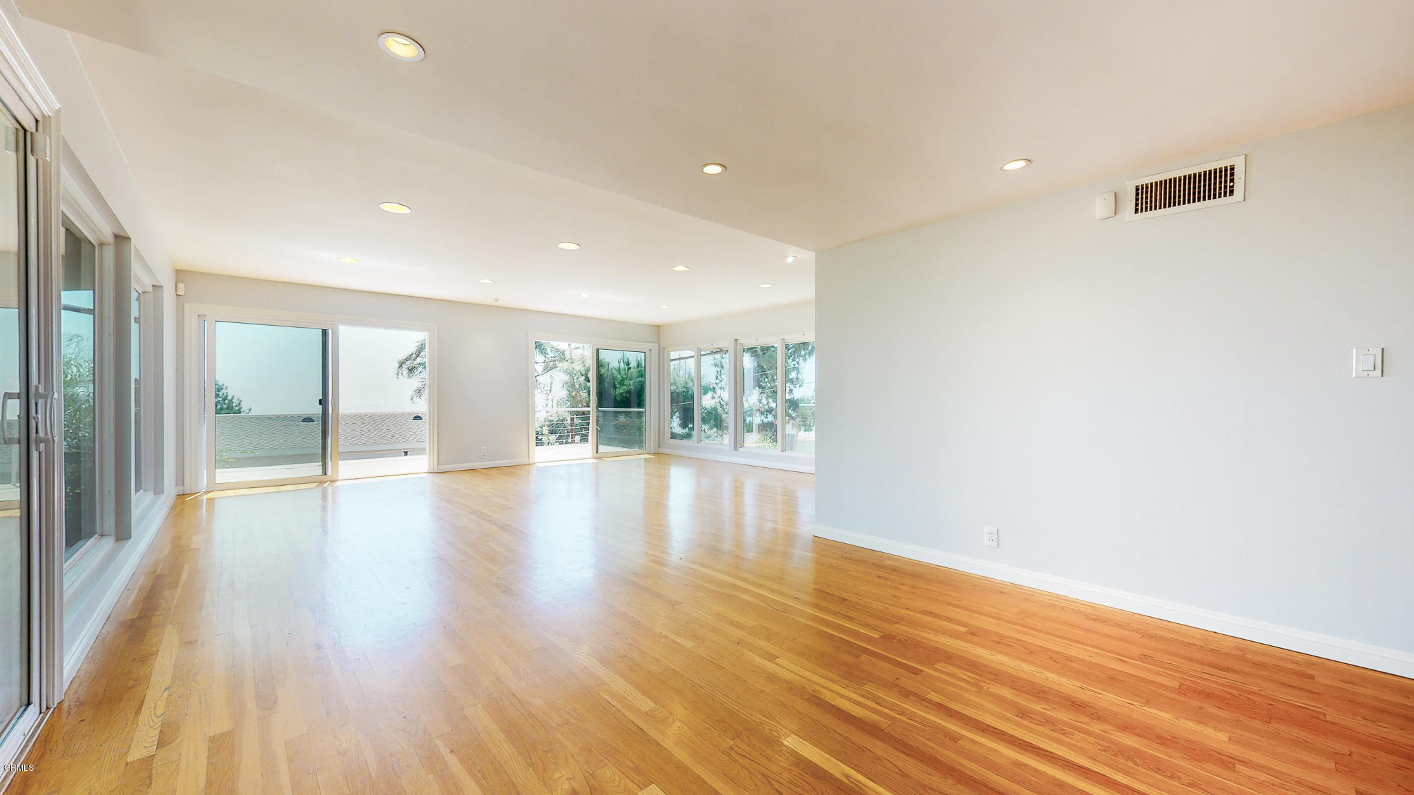 1610 Carriage House Road Pasadena, CA 91107 - Photo 16 of 54 a view of an empty room with wooden floor and a window