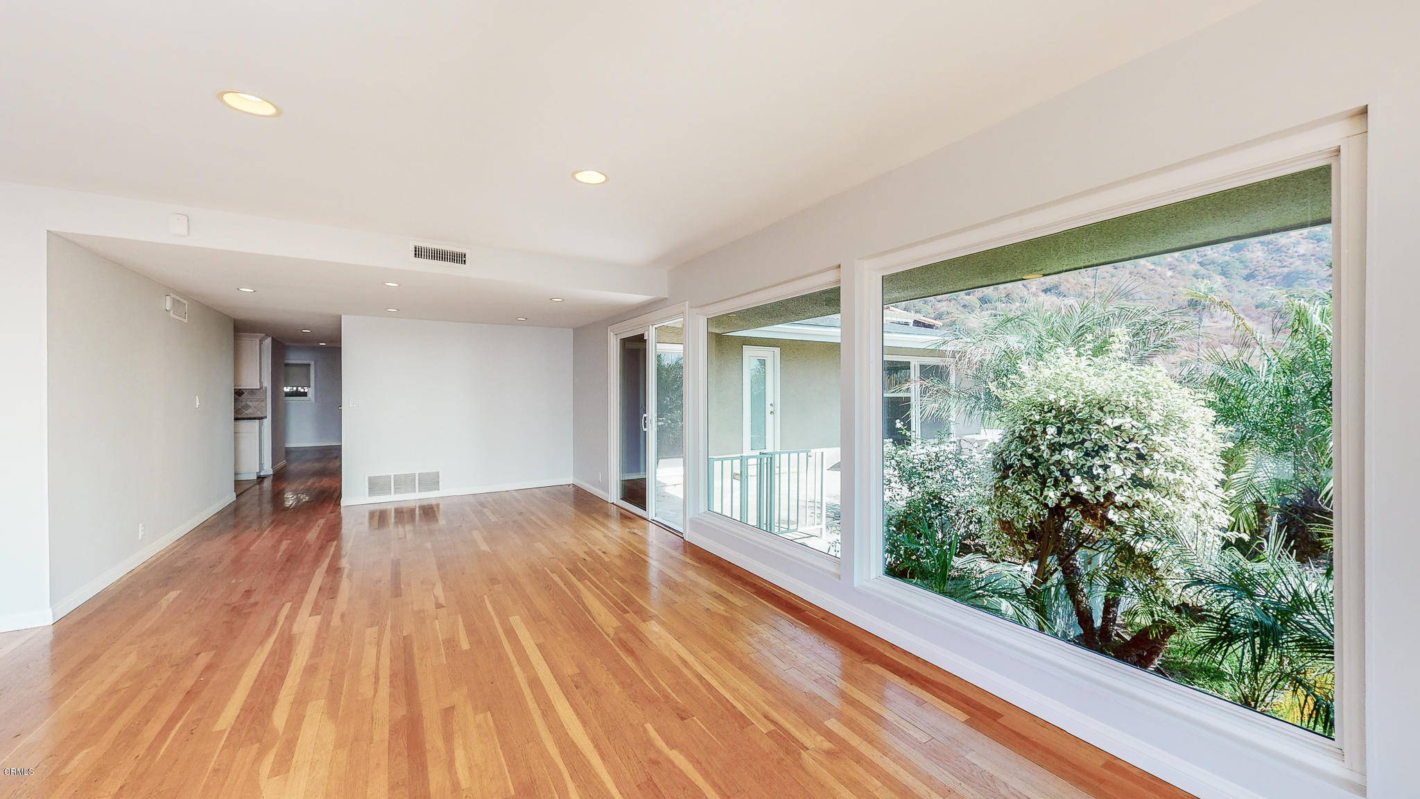 1610 Carriage House Road Pasadena, CA 91107 - Photo 18 of 54 a view of an empty room with wooden floor and a window