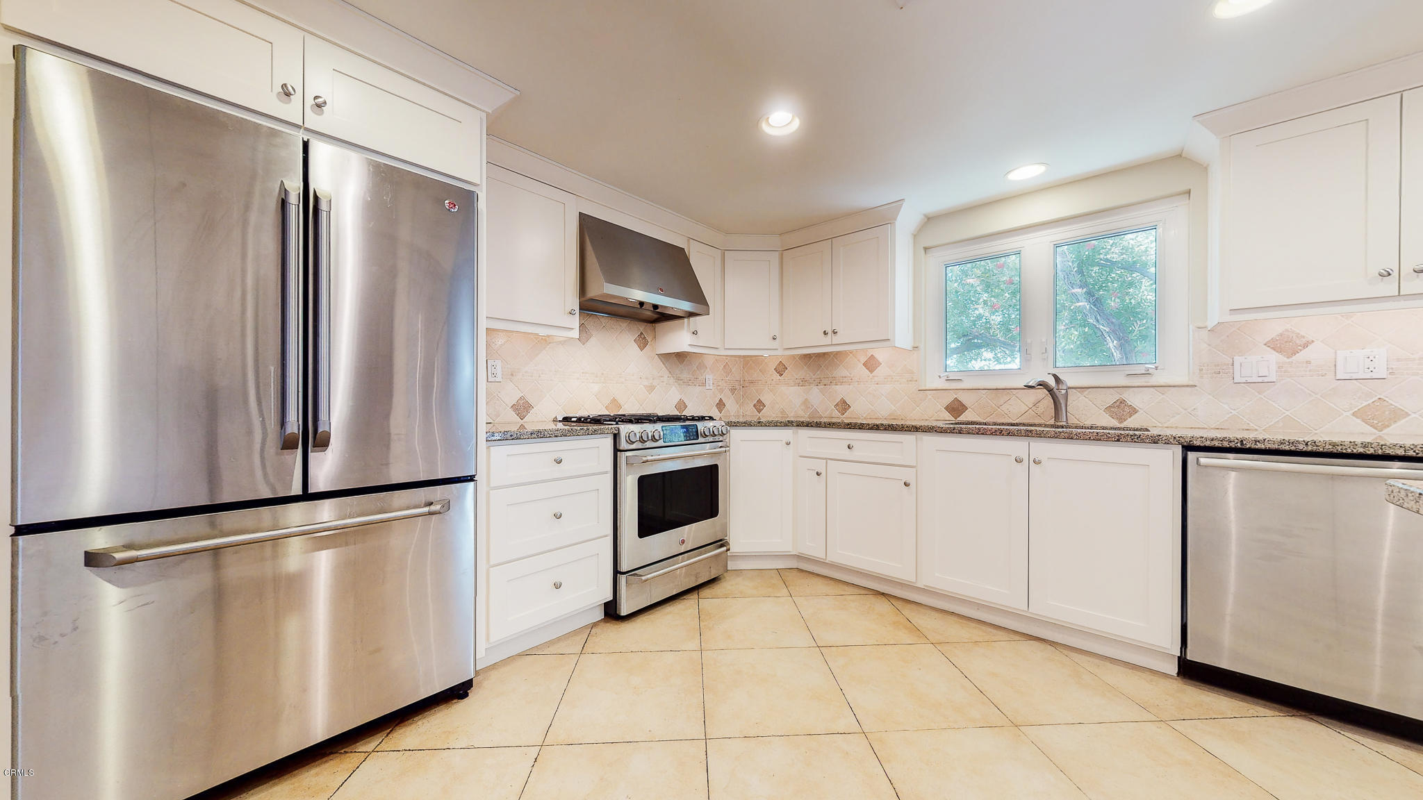 1610 Carriage House Road Pasadena, CA 91107 - Photo 25 of 54 a kitchen with white cabinets stainless steel appliances and window