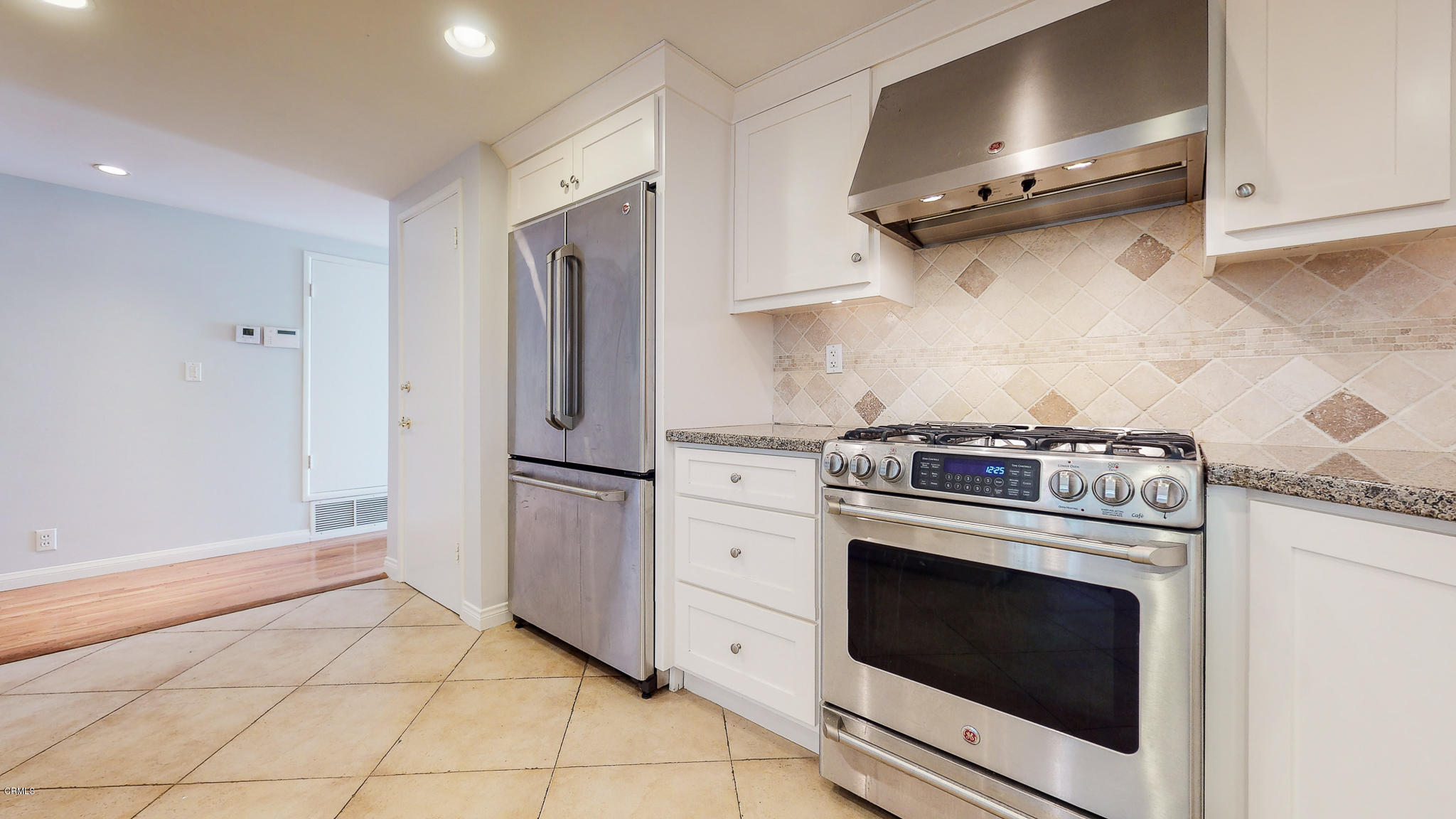1610 Carriage House Road Pasadena, CA 91107 - Photo 31 of 54 a kitchen with stainless steel appliances white cabinets and a stove top oven