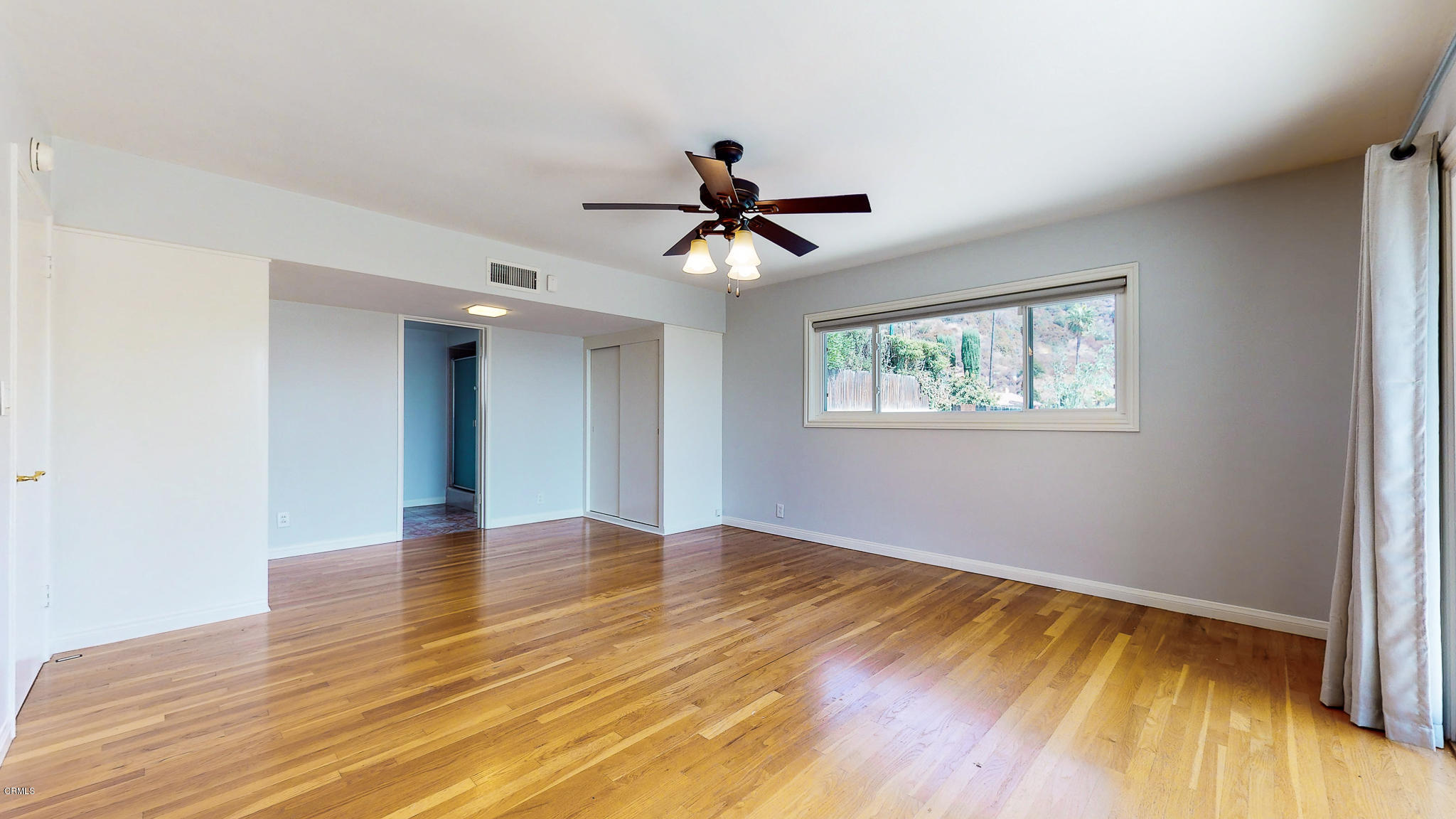 1610 Carriage House Road Pasadena, CA 91107 - Photo 38 of 54 a view of an empty room with window and wooden floor