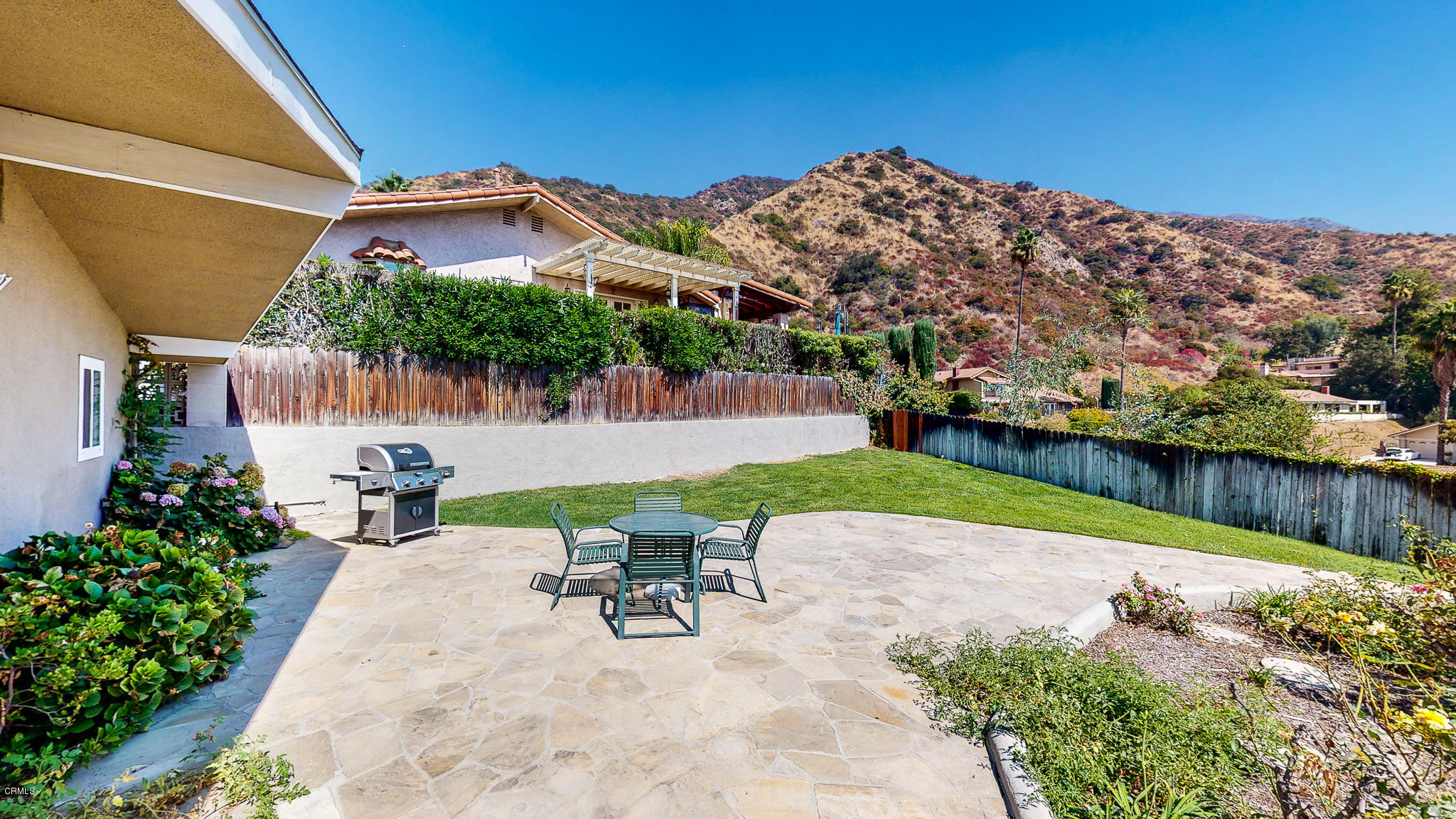 1610 Carriage House Road Pasadena, CA 91107 - Photo 47 of 54 a view of a patio with table and chairs under an umbrella