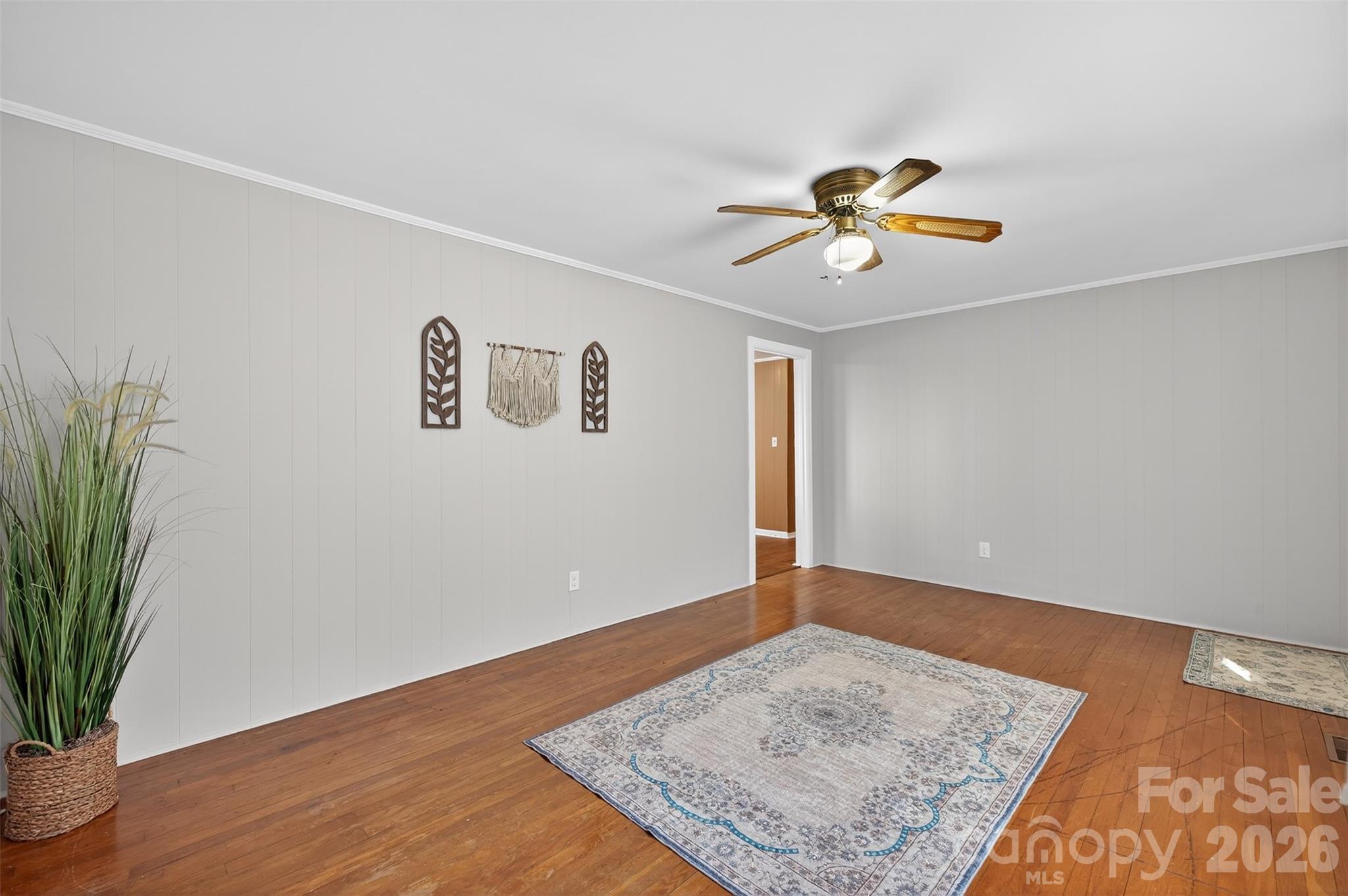 1708 Emmanuel Church Road Conover, NC 28613 - Photo 16 of 27 a view of a livingroom with wooden floor and a ceiling fan