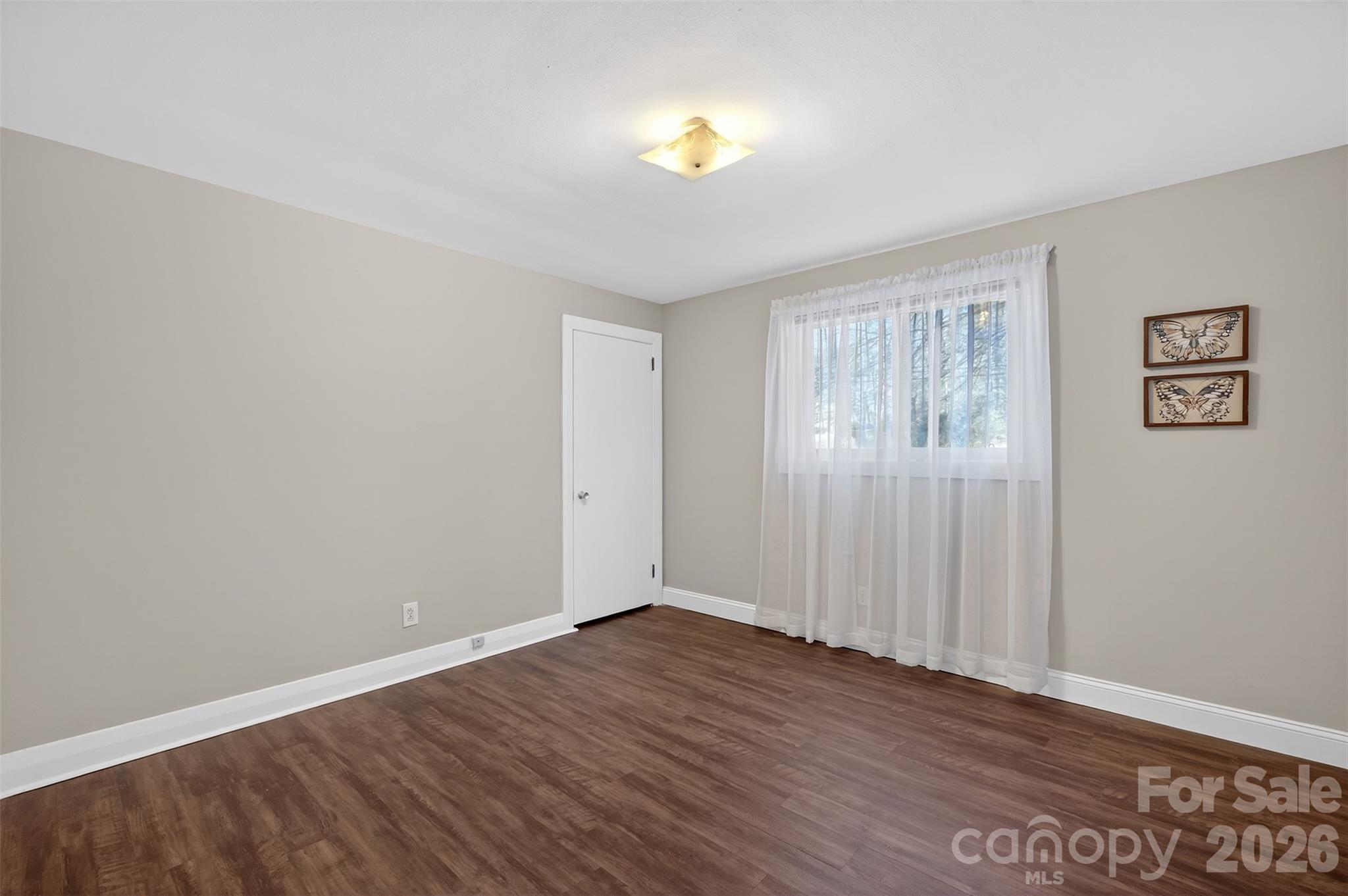 1708 Emmanuel Church Road Conover, NC 28613 - Photo 17 of 27 a view of an empty room with wooden floor and a window