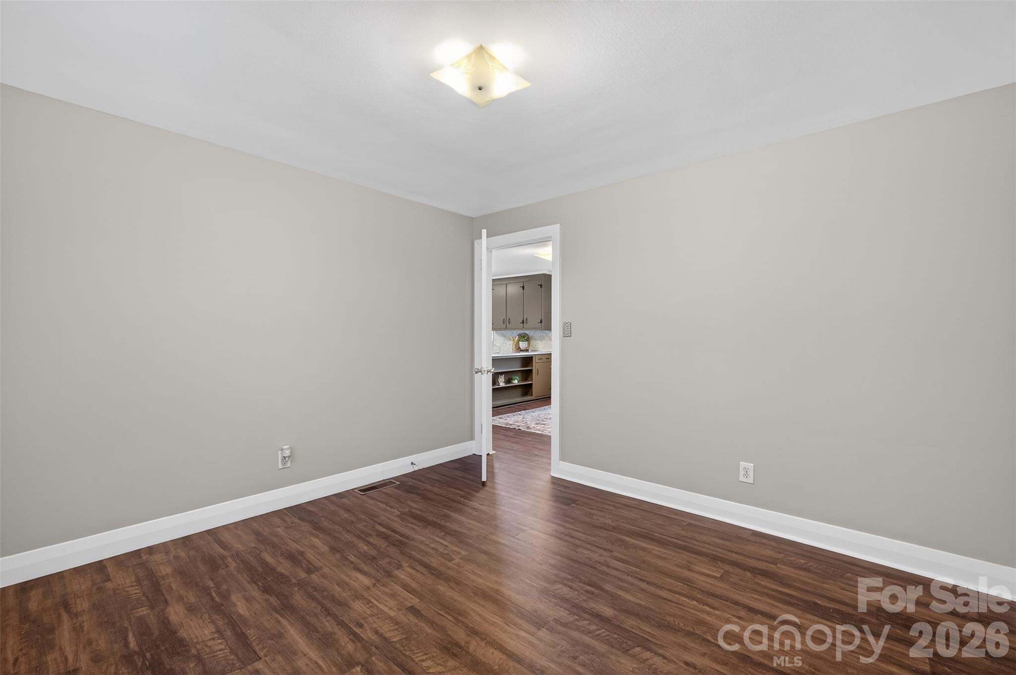 1708 Emmanuel Church Road Conover, NC 28613 - Photo 18 of 27 a view of an empty room with wooden floor and a window