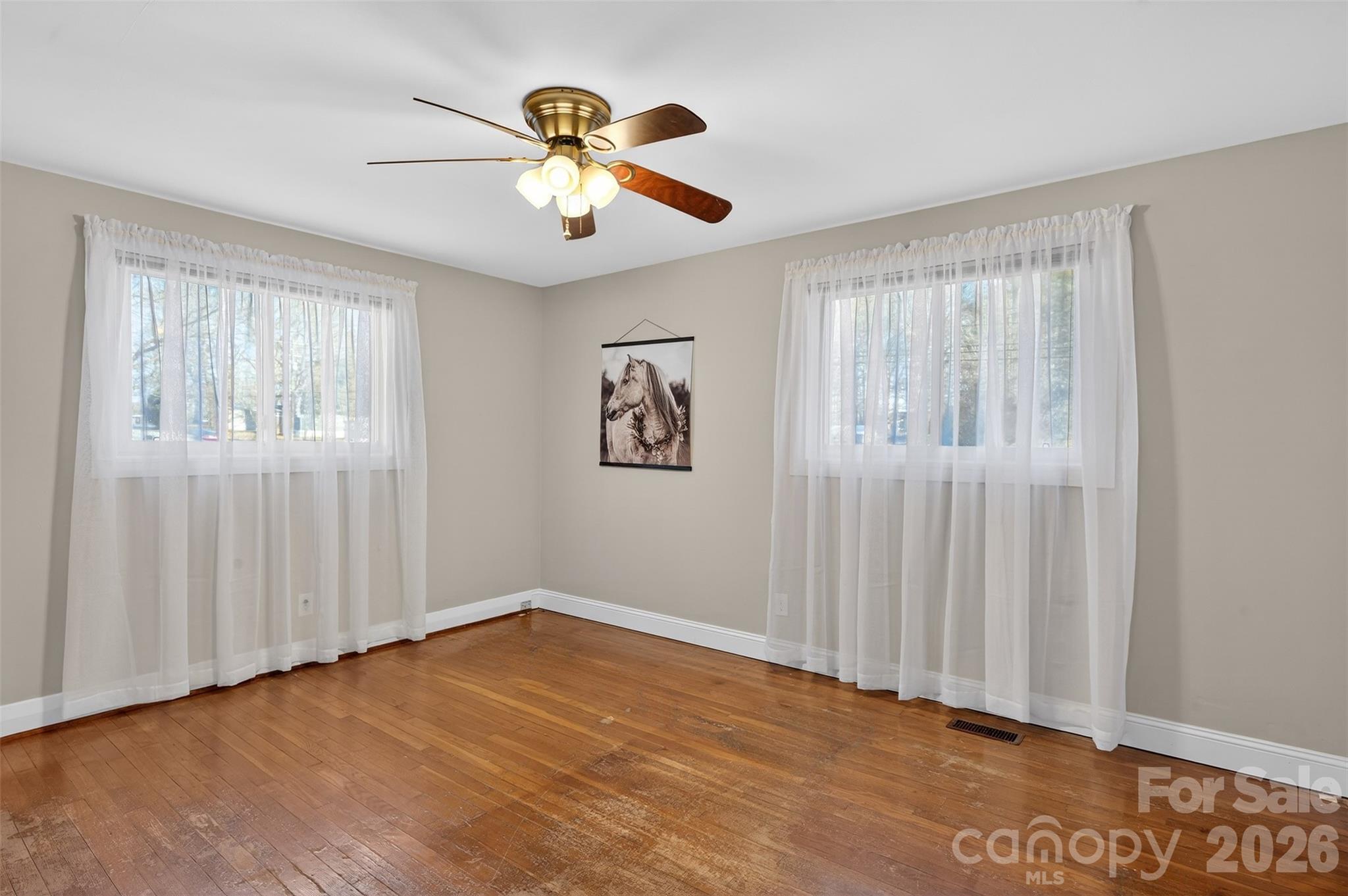 1708 Emmanuel Church Road Conover, NC 28613 - Photo 21 of 27 wooden floor in an empty room with a window
