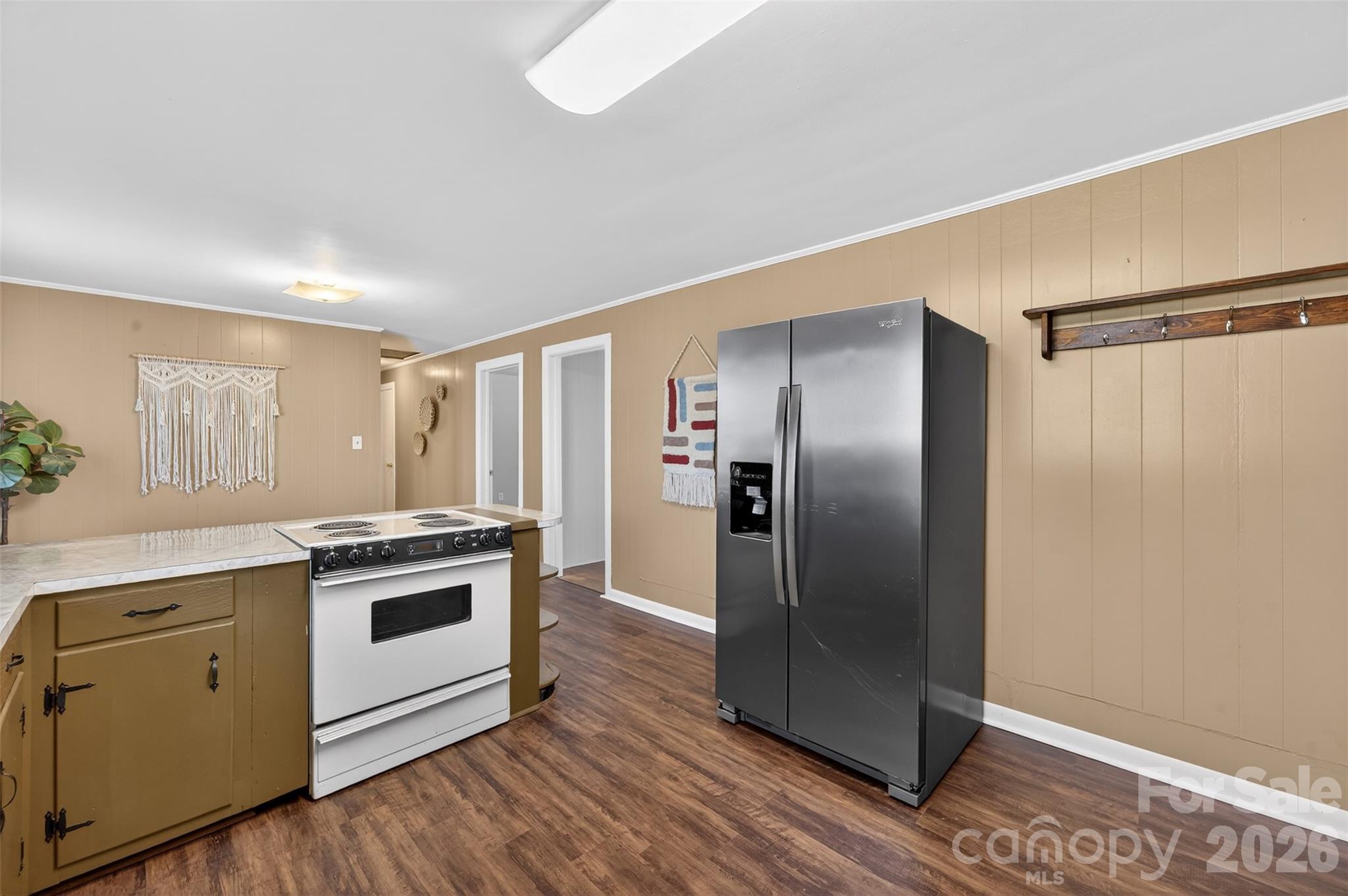 1708 Emmanuel Church Road Conover, NC 28613 - Photo 10 of 27 a kitchen with stainless steel appliances granite countertop a refrigerator a stove and a sink with wooden floors