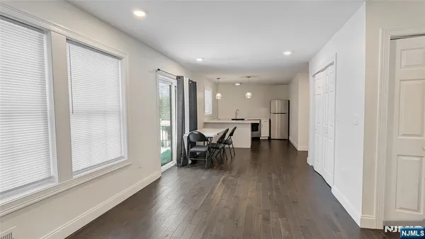 a dining room with furniture and wooden floor