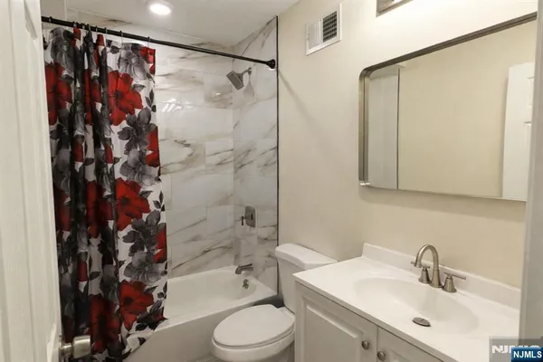 a room with water heater and wooden cabinets